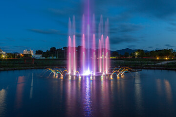 Fountain view at midnight park with colorful lights
