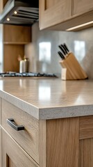 A closeup of a modern kitchen countertop with wooden cabinets and appliances