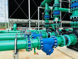 gas pipe and valves. Industrial cooling tower system with metal piping, heat exchangers, and...