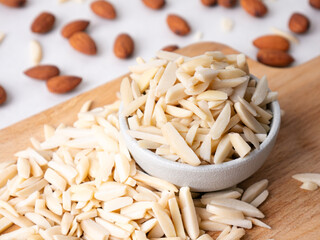 Almond and White Almond Stick set on wooden board and white background.