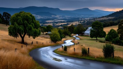 Scenic Winding Country Road through Lush Green Valley Farm House and Mountains