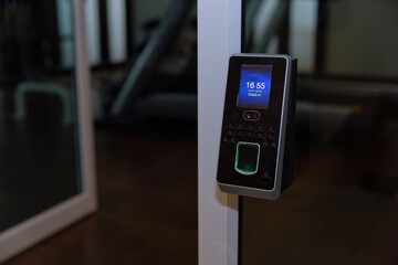 fingerprints scanner machine on glass wall at front lobby