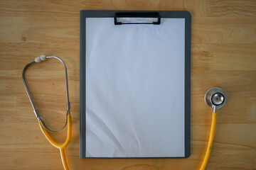 Blank clipboard with stethoscope placed on top in a medical or healthcare setting