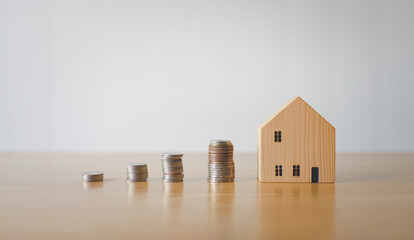 Wooden house model sitting on a wooden floor representing home and real estate concept