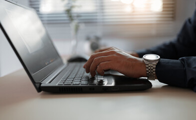 Businessman typing on laptop working in office