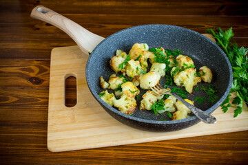 Appetizing fried cauliflower on a dark kitchen surface