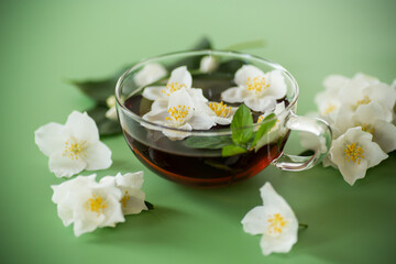 Green tea with jasmine in a glass teapot from above