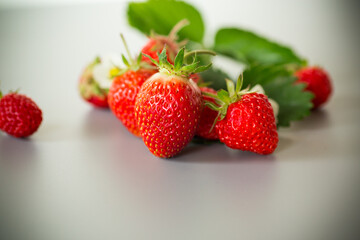 Top view of red strawberries with a gray background