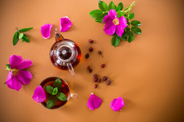Aromatic natural drink with rosehip petals and a sprig of mint