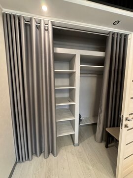 Modern Open Closet with Gray Curtains and Shelving System
