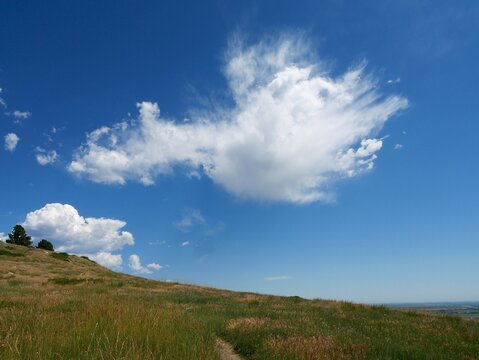 Dramatic Summer Clouds over Grassy Slopes of Hogback Ridge Trail, Boulder, Colorado