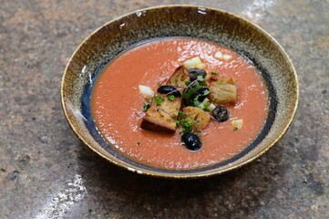 Tomato gazpacho soup with olives, garlic and croutons