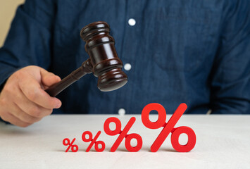 A judge with a gavel and rising interest rates. Regulatory decisions impacting financial markets,...