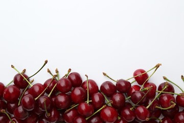 Fresh ripe cherries on white background, flat lay. Space for text