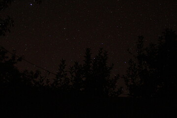 time lapse of stars fall and constellations in night sky with northern lights