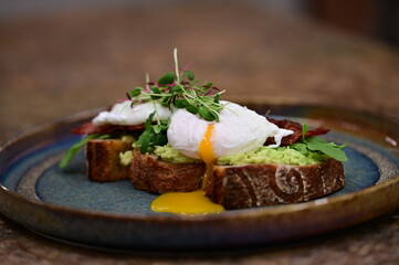 close up serving avocado toast with egg
