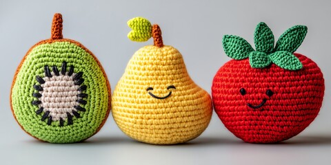 Colorful crocheted fruits with smiling faces, showcasing creativity and playfulness on a light background.