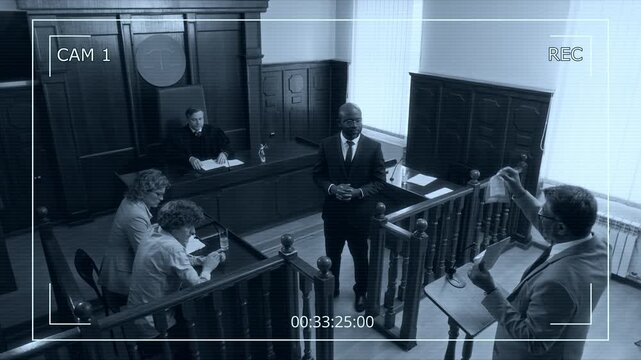 CCTV footage of lawyers presenting plastic-wrapped evidence to judge to accuse young man with crime in court