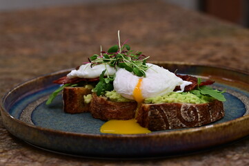 close up serving avocado toast with egg