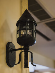 black wrought iron wall lamp indoors with rustic design