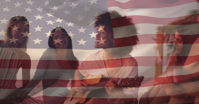 Jamming friends strumming acoustic guitar on low couch, cushions in living room with flag overlay