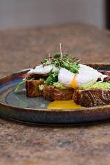 close up serving avocado toast with egg