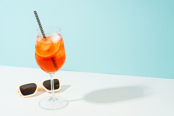Aperol Spritz, traditional summer cocktail at blue background. Sunny tropical holidays background.