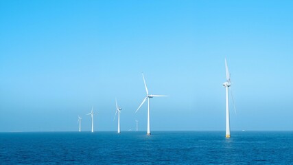 Windmills in water blue sky