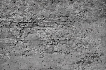 gray background, in the photo an old brick wall and gray plaster