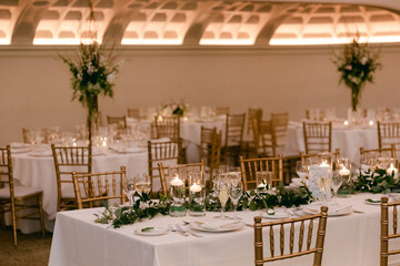 Elegant dining setup with floral decorations for a special event at an indoor venue