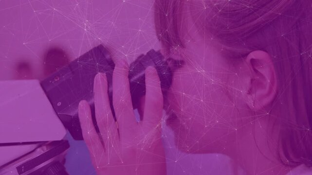 girl placing eye on microscope and turning focus knob causing animated rings for lab specimen