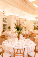 Elegant banquet hall setup with floral centerpieces ready for evening celebration in luxurious venue