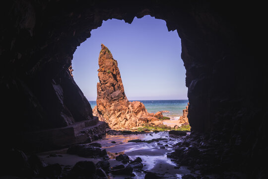 Coastal cave on island beach - Powered by Adobe