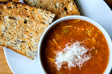Italian Style Minestrone Soup Topped With Cheese Seved With Toast