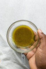 Overhead view of chicken stock in a bowl, top view of whole chicken stock