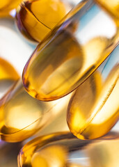 Close-up of shiny yellow vitamin capsules, healthy concept