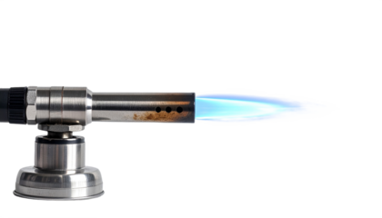 Intense blue flame emanating from a metal culinary torch against a stark black backdrop showcasing precision cooking, transparent background