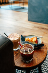 Delightful afternoon at a cozy cafe with dirty chai, almond cake, and iced americano