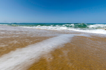waves on the beach Scivu beach with nice sand and rocks in Sardinia, an island of Italy in the mediterranean sea. 