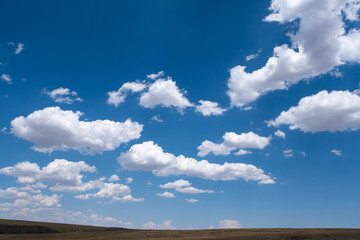 White airy clouds in a blue sky. Summer fluffy clouds, Beautiful sky with clouds, background for your projects.