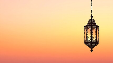 Ornate lantern hanging against a soft sunset