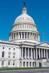 The majestic dome of the U.S. Capitol, Washington D.C., stands prominently against a vivid blue sky.