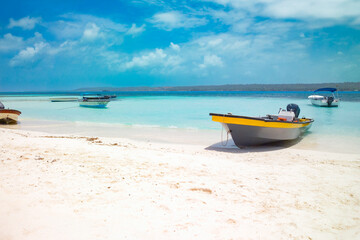 Sandy cays of San Andres Island, Colombia, with vibrant turquoise waters and boats resting on...