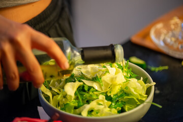 A vivid macro shot capturing a woman slicing a fresh lemon and squeezing its juice over a colorful salad, highlighting citrus texture and freshness in culinary action.