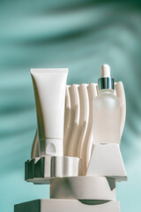 A soothing cream and a peptide serum are displayed on sculpted white pedestals with a flowing aqua...