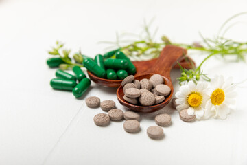 Alternative medicine herbal capsule organic drug on wooden background.Assortment of herbal and...