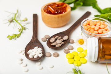 Alternative medicine herbal capsule organic drug on wooden background.Assortment of herbal and...