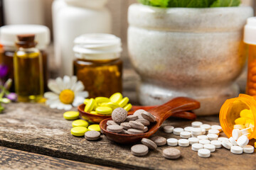 Alternative medicine herbal capsule organic drug on wooden background.Assortment of herbal and...
