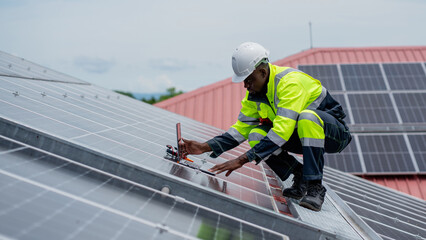 Service engineer checking solar cell on the roof for maintenance if there is a damaged part....
