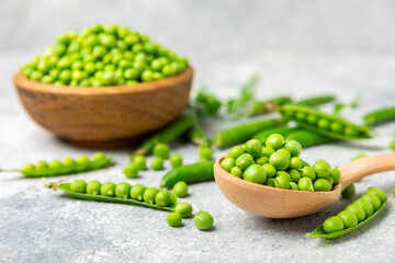 Fresh green pea pods with green peas on a wooden background. Sweet green peas. Green pea beans vegetables. Vegan. healthy vegetable. Copy space